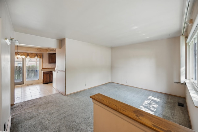 31565 Hayes Rd, Warren, MI 48088 - unfurnished room with light carpet, baseboards, a baseboard radiator, and light tile patterned floors