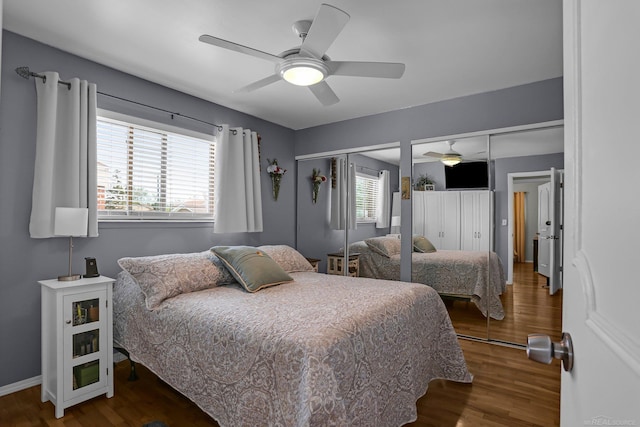 28052 Loretta Ave, Warren, MI 48092 - bedroom featuring two closets, wood finished floors, baseboards, and a ceiling fan
