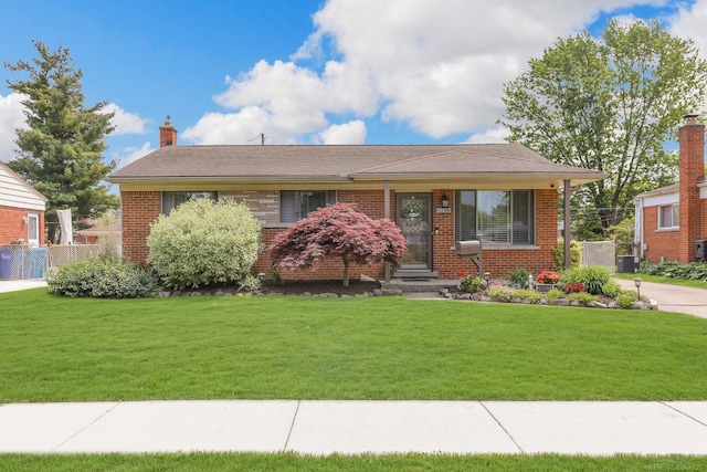 28052 Loretta Ave, Warren, MI 48092 - view of front of house with a front lawn, brick siding, and a chimney