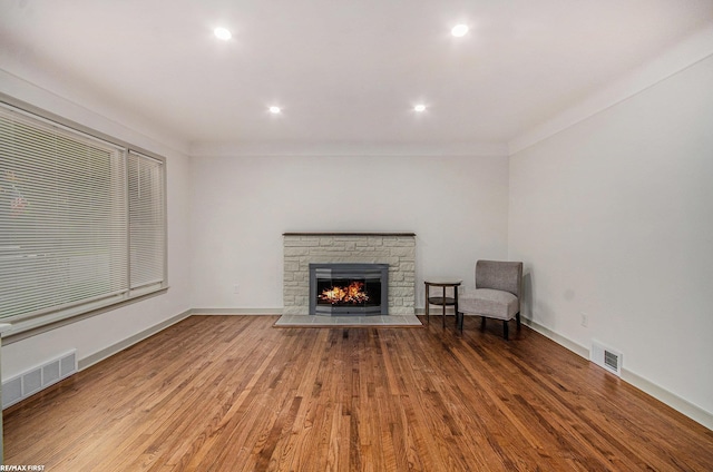 17844 Stephens St, Eastpointe, MI 48021 - unfurnished living room with wood finished floors, a stone fireplace, baseboards, recessed lighting, and crown molding