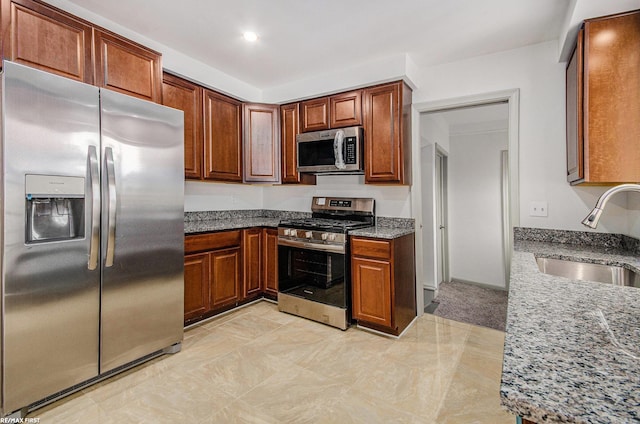 17844 Stephens St, Eastpointe, MI 48021 - kitchen featuring stainless steel appliances, a sink, stone counters, brown cabinets, and recessed lighting