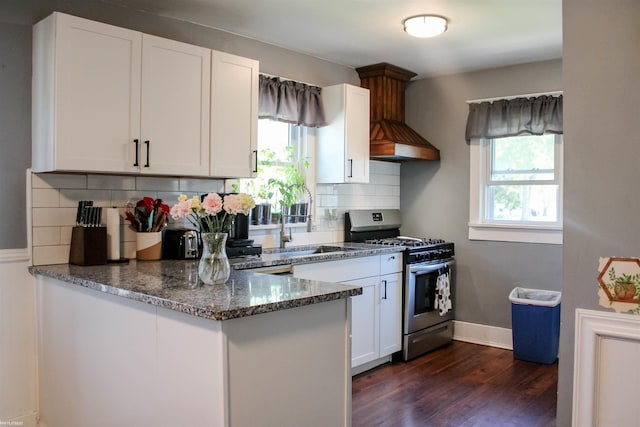 1002 Garfield St, Port Huron, MI 48060 - kitchen featuring stainless steel range with gas cooktop, dark stone counters, dark wood finished floors, white cabinets, and plenty of natural light