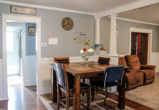 1002 Garfield St, Port Huron, MI 48060 - dining area featuring ornate columns, wood finished floors, a wainscoted wall, and healthy amount of natural light