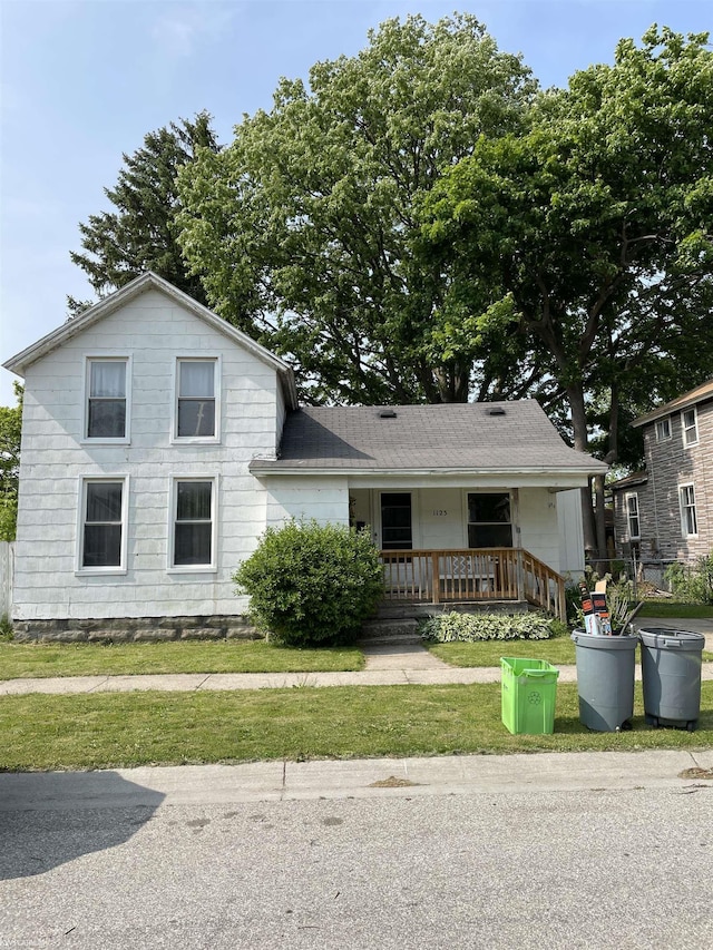 1123 Gillett St, Port Huron, MI 48060 - view of front of home with a porch and a front yard