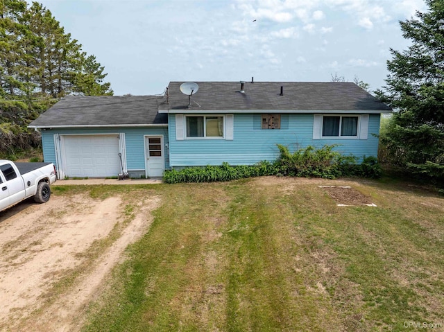 8096 Garth Point 25.25 Ln Rd, Rapid River, MI 49878 - view of front of home featuring driveway, an attached garage, and a front lawn