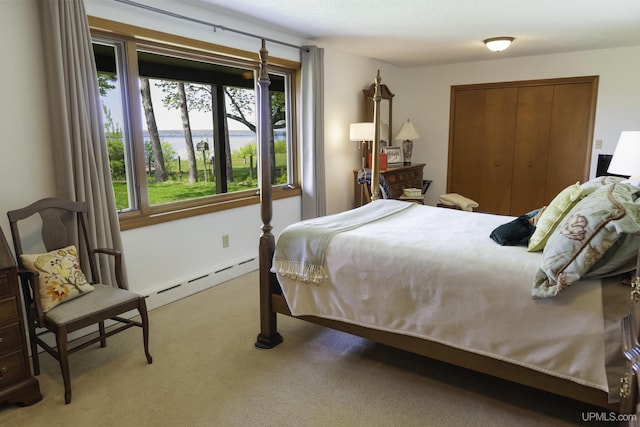 1426 Washington St, Munising, MI 49862 - carpeted bedroom featuring a baseboard radiator, a closet, and a water view