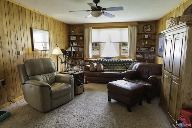 1426 Washington St, Munising, MI 49862 - living area with wooden walls, ceiling fan, and carpet flooring