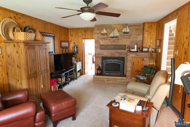 1426 Washington St, Munising, MI 49862 - living area featuring wooden walls, carpet, ceiling fan, and a large fireplace