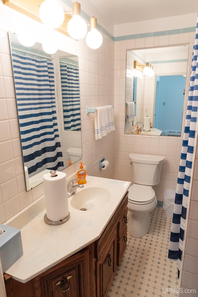 1426 Washington St, Munising, MI 49862 - bathroom with tile walls, toilet, vanity, and a shower with curtain