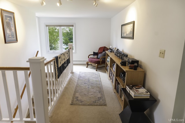 1426 Washington St, Munising, MI 49862 - hall with a baseboard heating unit, an upstairs landing, carpet flooring, and rail lighting