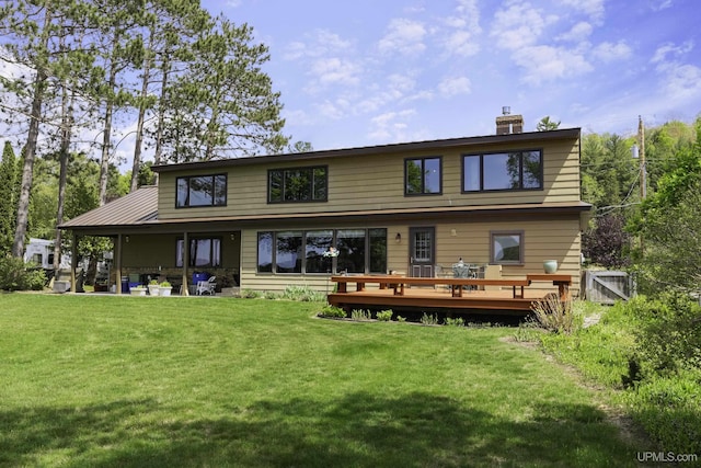 1426 Washington St, Munising, MI 49862 - rear view of property with a lawn, a deck, and a chimney