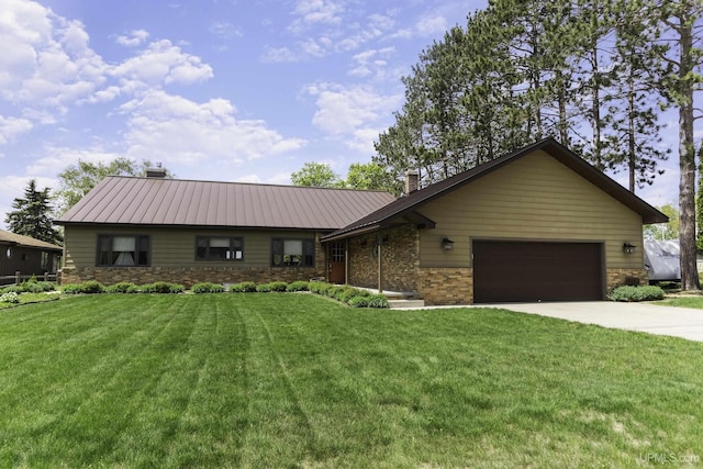 1426 Washington St, Munising, MI 49862 - ranch-style house with a chimney, concrete driveway, a front lawn, and an attached garage