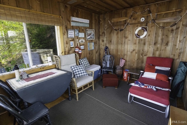 1426 Washington St, Munising, MI 49862 - living area featuring wooden walls, carpet, and wood ceiling