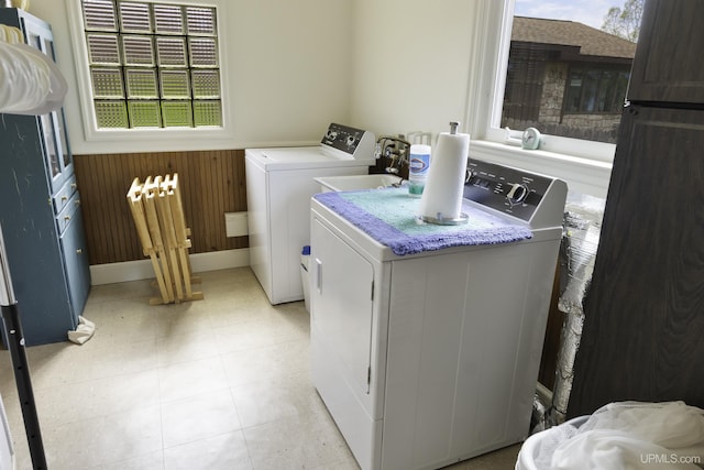 1426 Washington St, Munising, MI 49862 - laundry area with independent washer and dryer, healthy amount of natural light, wainscoting, and wooden walls