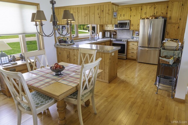 1426 Washington St, Munising, MI 49862 - kitchen featuring stainless steel appliances, a sink, plenty of natural light, and light wood-style floors