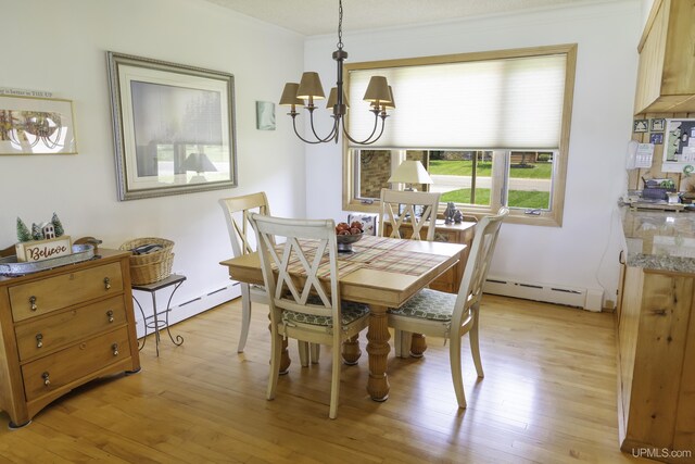 1426 Washington St, Munising, MI 49862 - dining room with a chandelier, light wood finished floors, a baseboard heating unit, and crown molding