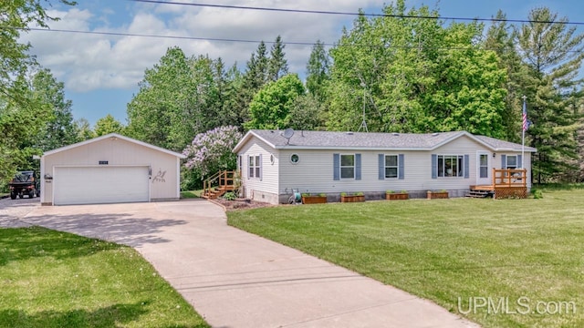 11745 T Rd, Rapid River, MI 49878 - manufactured / mobile home featuring a detached garage, an outbuilding, a front yard, a wooden deck, and crawl space