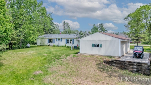 11745 T Rd, Rapid River, MI 49878 - back of house with a lawn and an outdoor structure