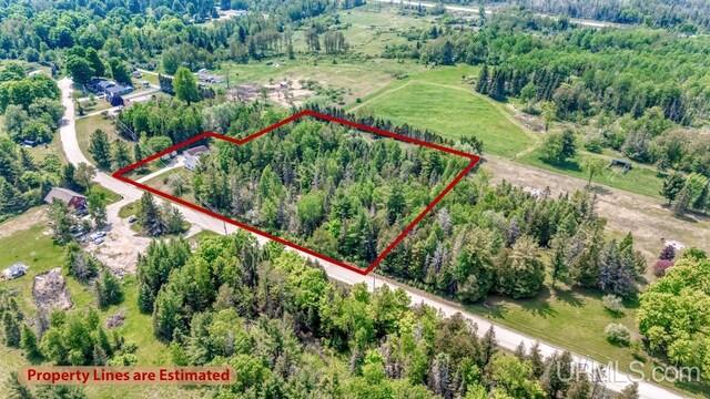 11745 T Rd, Rapid River, MI 49878 - aerial overview of property's location featuring property parcel outlined and a heavily wooded area