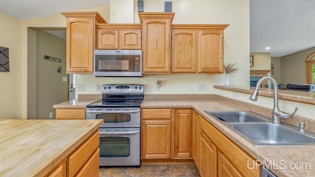 W5716 Warner Ln, Norway, MI 49870 - kitchen featuring stainless steel appliances, a sink, butcher block counters, and recessed lighting