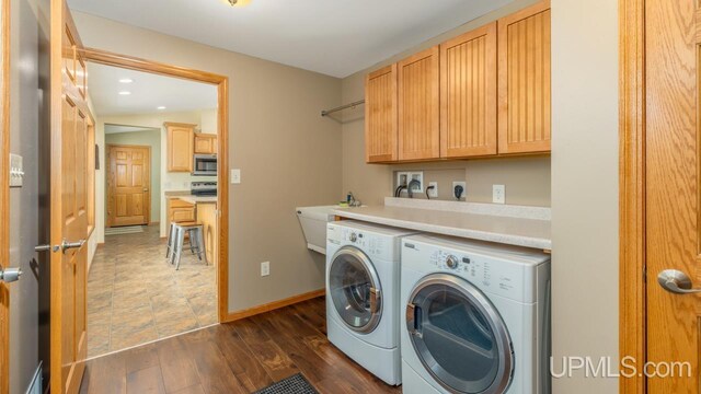 W5716 Warner Ln, Norway, MI 49870 - washroom featuring separate washer and dryer, cabinet space, dark wood-type flooring, baseboards, and recessed lighting