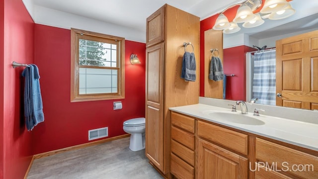 W5716 Warner Ln, Norway, MI 49870 - bathroom with toilet, vanity, a shower, and baseboards