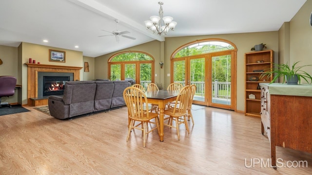 W5716 Warner Ln, Norway, MI 49870 - dining space with light wood-type flooring, a glass covered fireplace, a chandelier, a ceiling fan, and recessed lighting