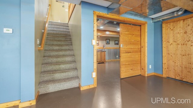 W5716 Warner Ln, Norway, MI 49870 - stairs featuring finished concrete floors and baseboards