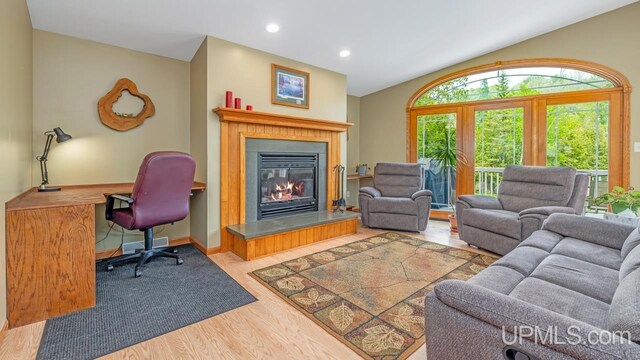 W5716 Warner Ln, Norway, MI 49870 - living room featuring wood finished floors, a glass covered fireplace, and recessed lighting