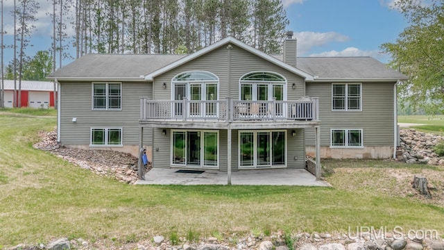 W5716 Warner Ln, Norway, MI 49870 - rear view of property featuring a yard, a chimney, a patio area, and a deck