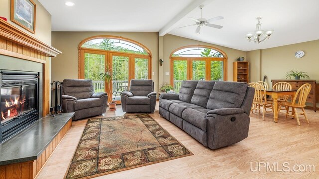 W5716 Warner Ln, Norway, MI 49870 - living area featuring light wood finished floors, a glass covered fireplace, a ceiling fan, a chandelier, and recessed lighting