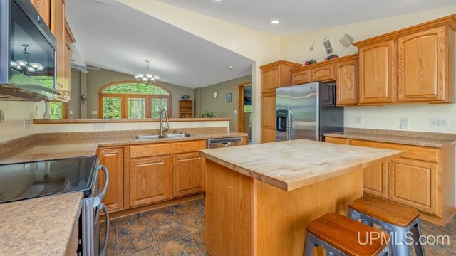 W5716 Warner Ln, Norway, MI 49870 - kitchen featuring stainless steel appliances, a sink, butcher block countertops, a center island, and a peninsula
