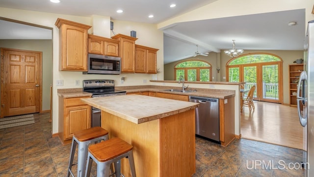 W5716 Warner Ln, Norway, MI 49870 - kitchen with stainless steel appliances, a peninsula, a sink, a kitchen island, and wooden counters