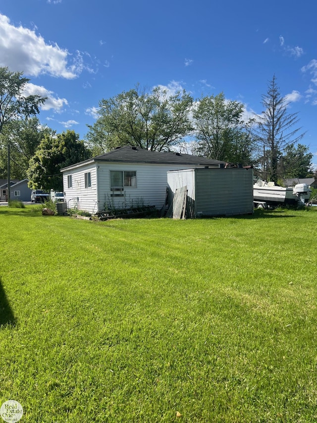 5441 Orchard Dr, East China, MI 48054 - back of house with a yard and central air condition unit