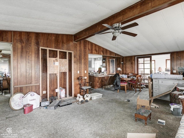 7150 Denissen St, Lexington, MI 48450 - living area with wood walls, ceiling fan, and carpet flooring