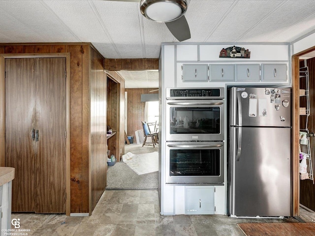 7150 Denissen St, Lexington, MI 48450 - kitchen with appliances with stainless steel finishes and wooden walls