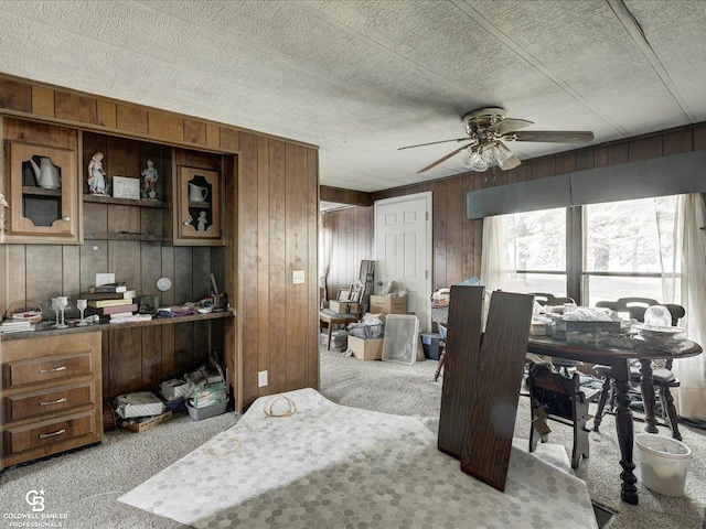 7150 Denissen St, Lexington, MI 48450 - dining area featuring carpet, ceiling fan, wooden walls, an office area, and a textured ceiling