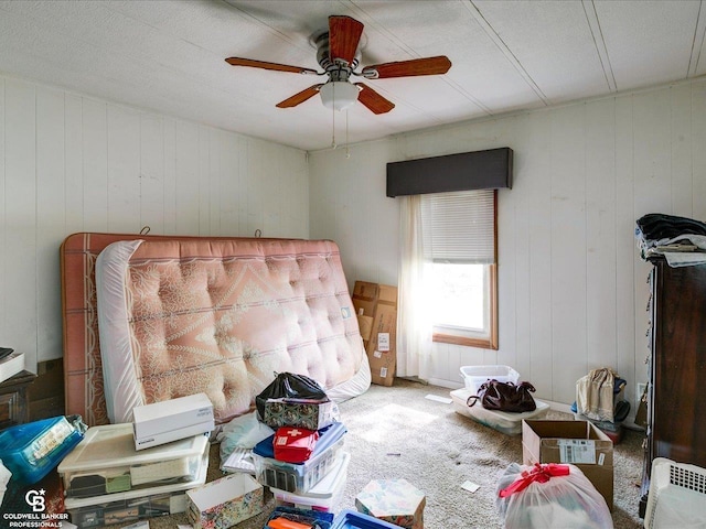 7150 Denissen St, Lexington, MI 48450 - bedroom with carpet, a ceiling fan, and wood walls