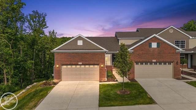 3091 Bridgewater Rd Unit # 28, Auburn Hills, MI 48326 - traditional home featuring concrete driveway, brick siding, a garage, and a yard