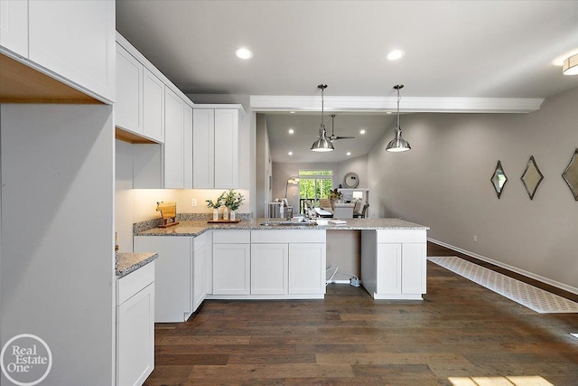 3091 Bridgewater Rd Unit # 28, Auburn Hills, MI 48326 - kitchen with a peninsula, recessed lighting, white cabinetry, dark wood-style flooring, and light stone countertops