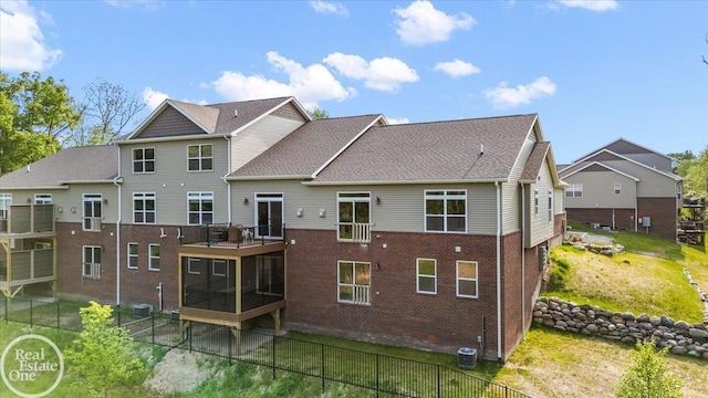 3091 Bridgewater Rd Unit # 28, Auburn Hills, MI 48326 - rear view of property featuring a sunroom and brick siding