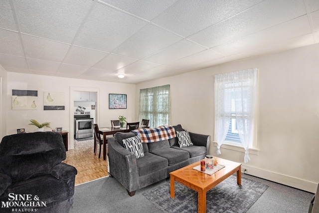 1317 Oak St, Port Huron, MI 48060 - living area featuring a drop ceiling and baseboards