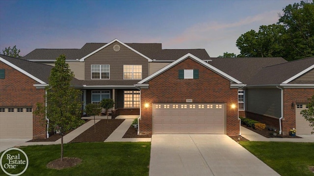 3095 Bridgewater Rd Unit # 30, Auburn Hills, MI 48326 - traditional home with driveway, brick siding, an attached garage, and a front yard