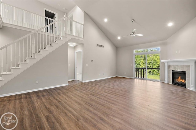 3095 Bridgewater Rd Unit # 30, Auburn Hills, MI 48326 - unfurnished living room with high vaulted ceiling, a ceiling fan, wood finished floors, a premium fireplace, and baseboards