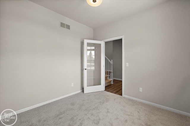 3095 Bridgewater Rd Unit # 30, Auburn Hills, MI 48326 - spare room featuring carpet floors, baseboards, and stairway