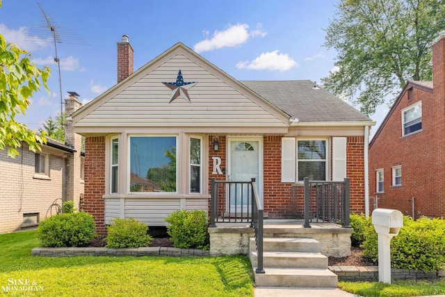 23016 California St, Saint Clair Shores, MI 48080 - bungalow-style house with brick siding, a front yard, and a shingled roof