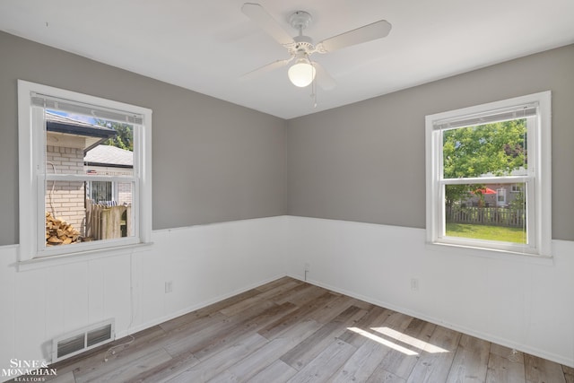 23016 California St, Saint Clair Shores, MI 48080 - empty room with wood finished floors, wainscoting, and a ceiling fan