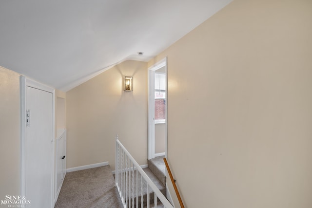23016 California St, Saint Clair Shores, MI 48080 - hallway featuring vaulted ceiling, an upstairs landing, carpet, and baseboards