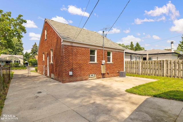 23016 California St, Saint Clair Shores, MI 48080 - back of house featuring brick siding, roof with shingles, a gate, and a patio