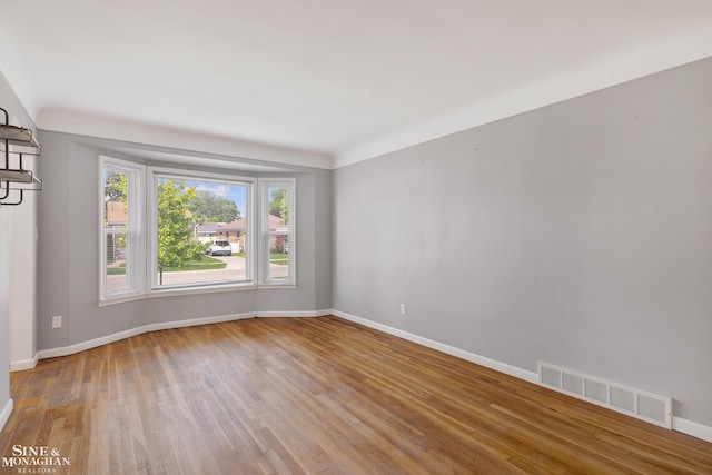 23016 California St, Saint Clair Shores, MI 48080 - spare room with baseboards and wood finished floors